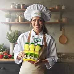 Chef Farah in white holding Farah oil bottles